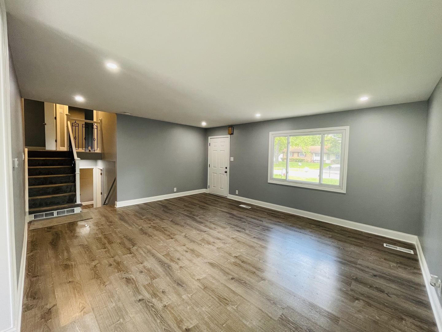 541 Spruce Road Bolingbrook, IL 60440 - Photo 3 of 21 an empty room with wooden floor and windows