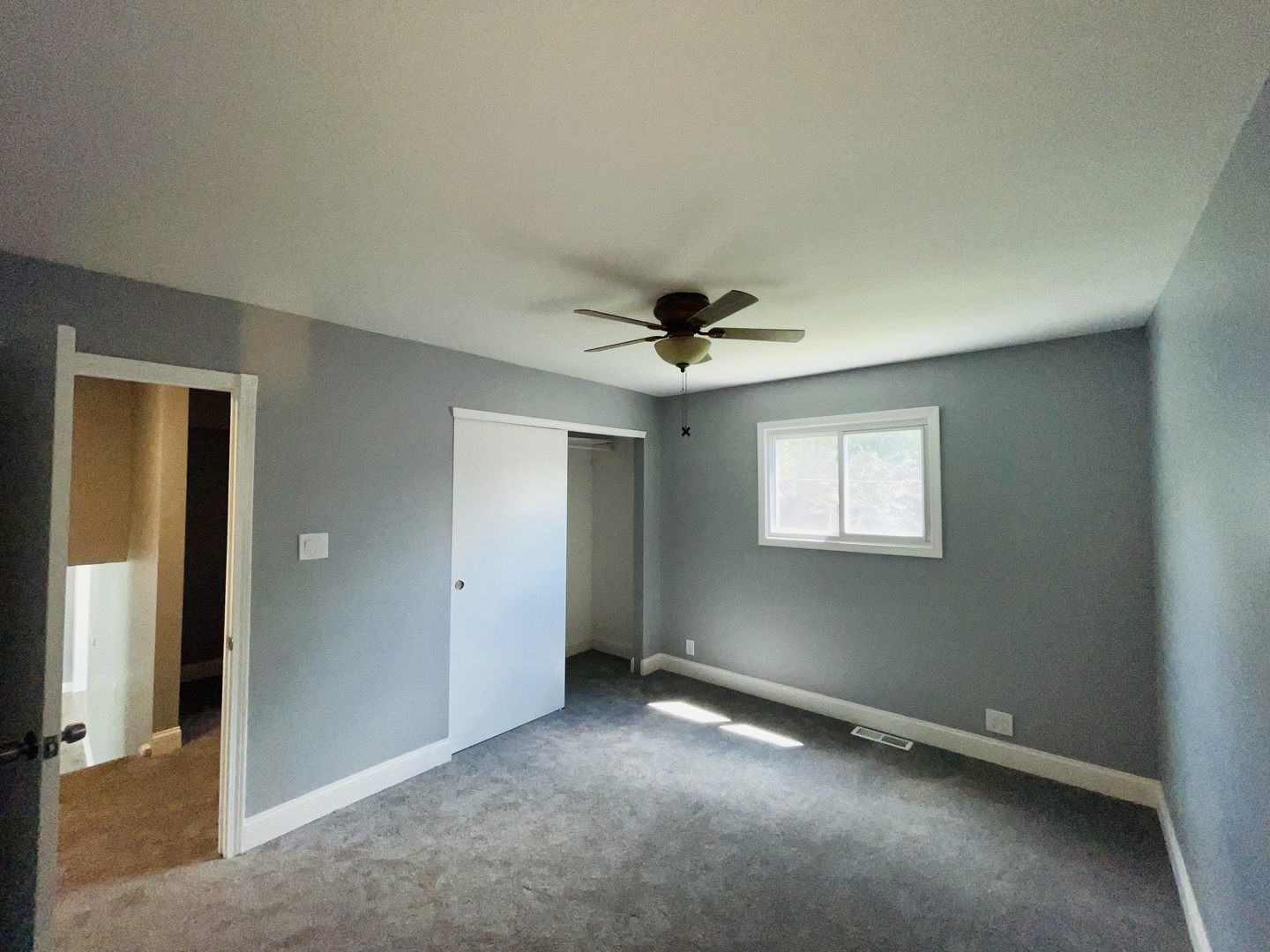541 Spruce Road Bolingbrook, IL 60440 - Photo 9 of 21 an empty room with a fan & a window