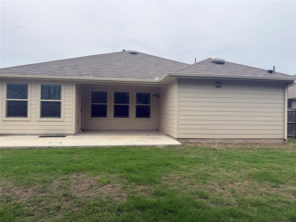 1004 Rising Moon Drive Fort Worth, TX 76052 - Photo 12 of 13 Expansive green lawn with a concrete patio