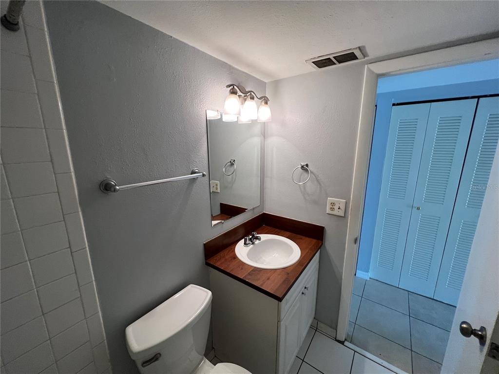 3206 West Azeele Street, Unit 100 Tampa, FL 33609 - Photo 13 of 15 a bathroom with a sink toilet and shower