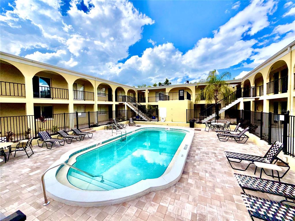 3206 West Azeele Street, Unit 100 Tampa, FL 33609 - Photo 2 of 15 a view of a house with swimming pool and sitting area