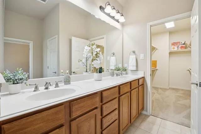 a spacious bathroom with a shower sink and mirror