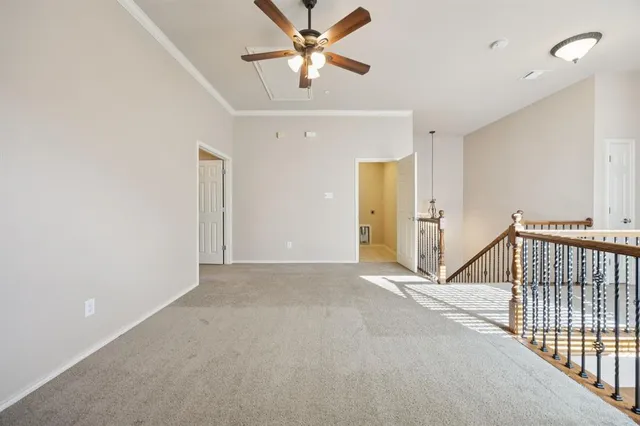 a view of a livingroom with a ceiling fan and window
