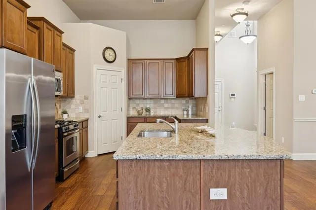 a spacious bathroom with a granite countertop double vanity sink and a large mirror