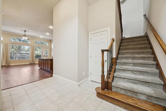 a view of a hallway with wooden floor and windows