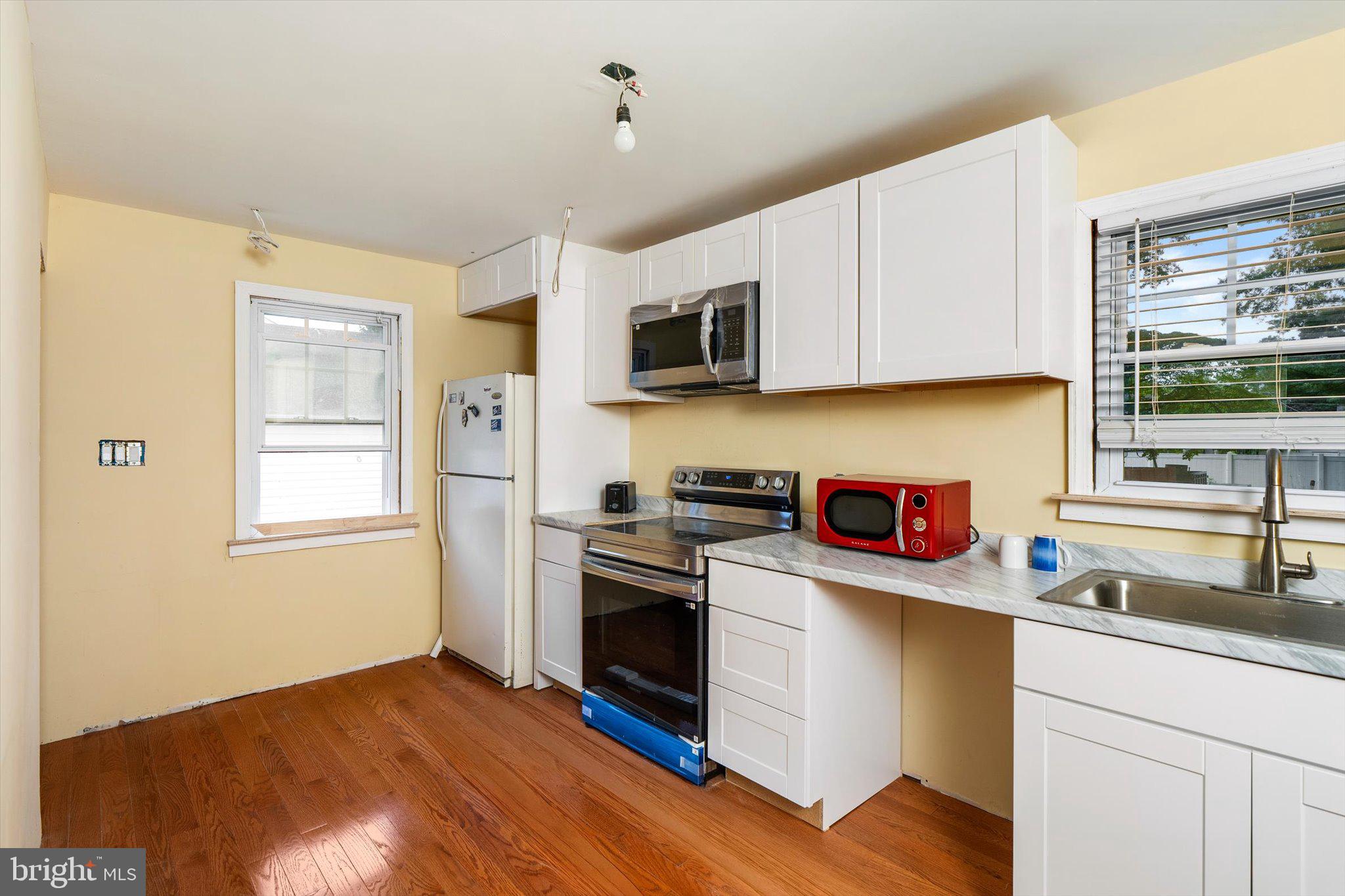 319 Station Road Roebling, NJ 08554 - Photo 4 of 15 a kitchen with granite countertop cabinets stainless steel appliances and a window