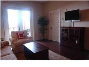 2108 Highway 30a Santa Rosa Beach, Unit 312 Santa Rosa Beach, FL 32459 - Photo 6 of 9 a living room with a flat screen tv and a refrigerator