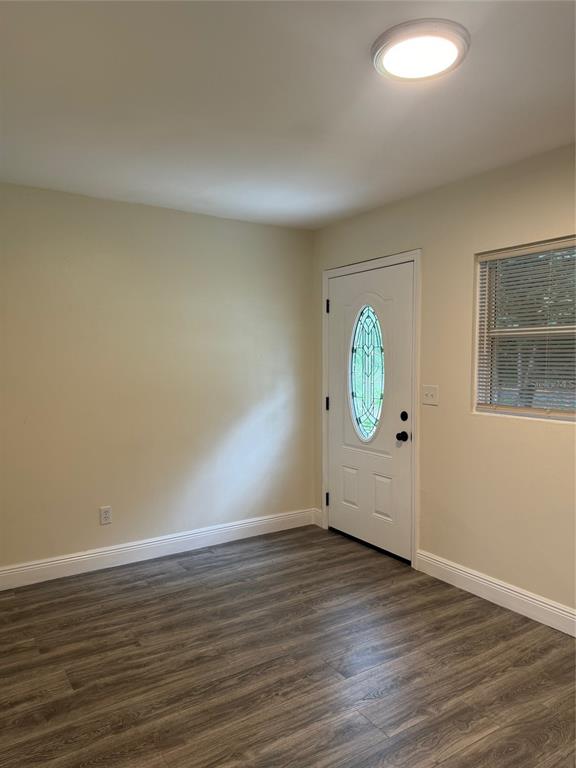 34825 Cutoff Road, Unit B Fruitland Park, FL 34731 - Photo 2 of 9 a view of an empty room with wooden floor and a window