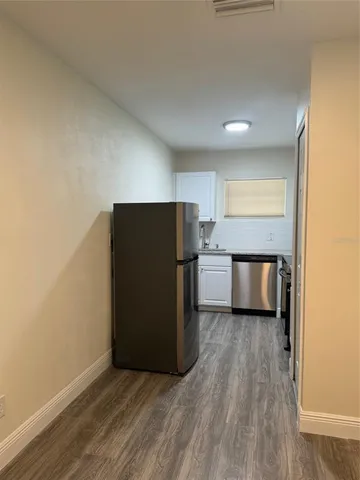 a view of a kitchen with a refrigerator a stove top oven and a fridge