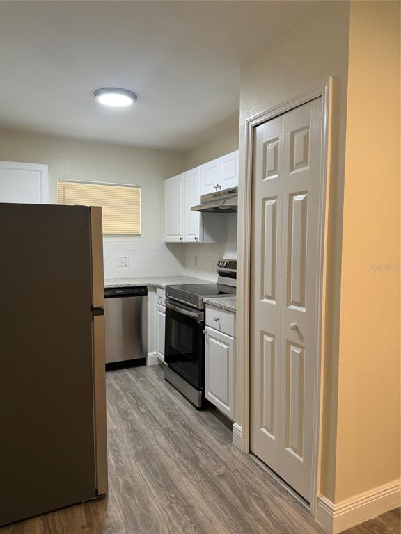 34825 Cutoff Road, Unit B Fruitland Park, FL 34731 - Photo 5 of 9 a kitchen with stainless steel appliances a refrigerator and a stove
