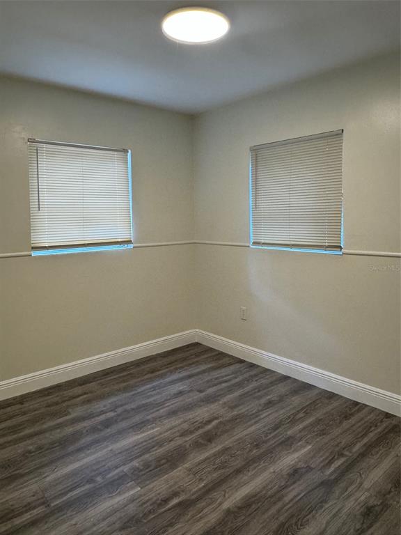 34825 Cutoff Road, Unit B Fruitland Park, FL 34731 - Photo 7 of 9 a view of an empty room with wooden floor and a window