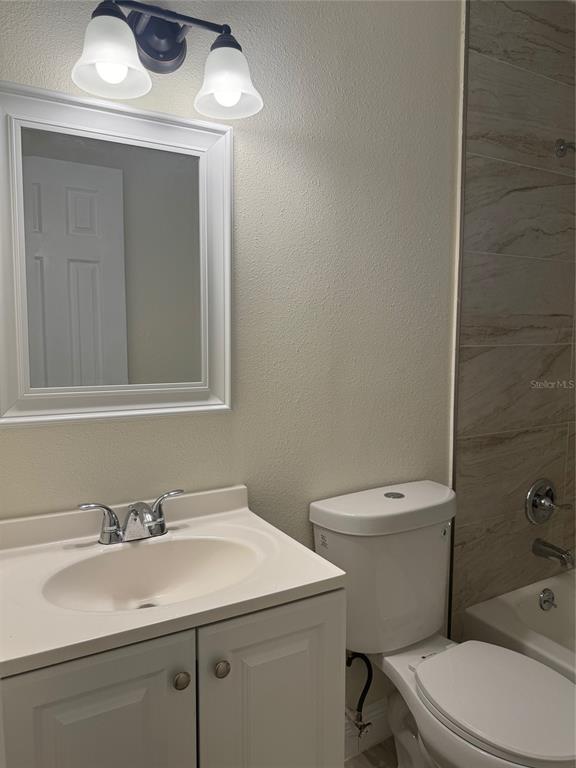 34825 Cutoff Road, Unit B Fruitland Park, FL 34731 - Photo 8 of 9 a bathroom with a sink a toilet and mirror