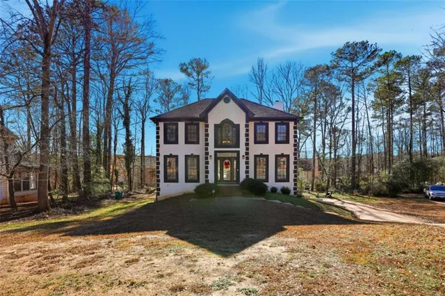 a front view of a house with a yard