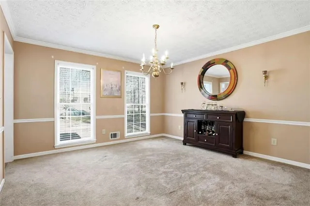 an empty room with a fireplace and a large window