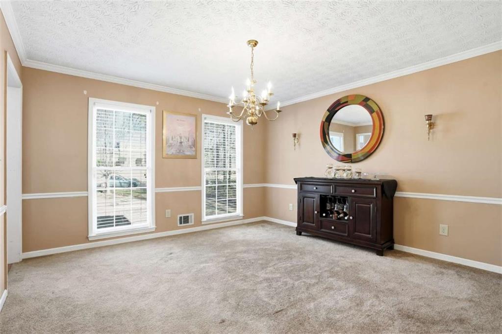 3811 Brookvale Place Decatur, GA 30034 - Photo 11 of 40 an empty room with a fireplace and a large window