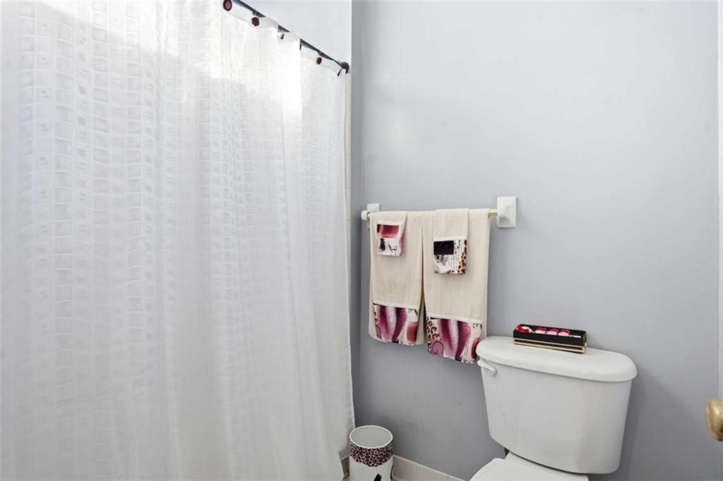 3811 Brookvale Place Decatur, GA 30034 - Photo 26 of 40 a bathroom with a toilet and a shower curtain