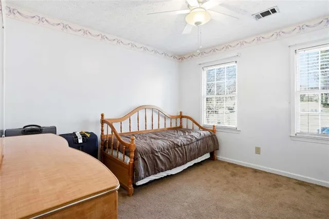 a spacious bedroom with two beds and a chandelier