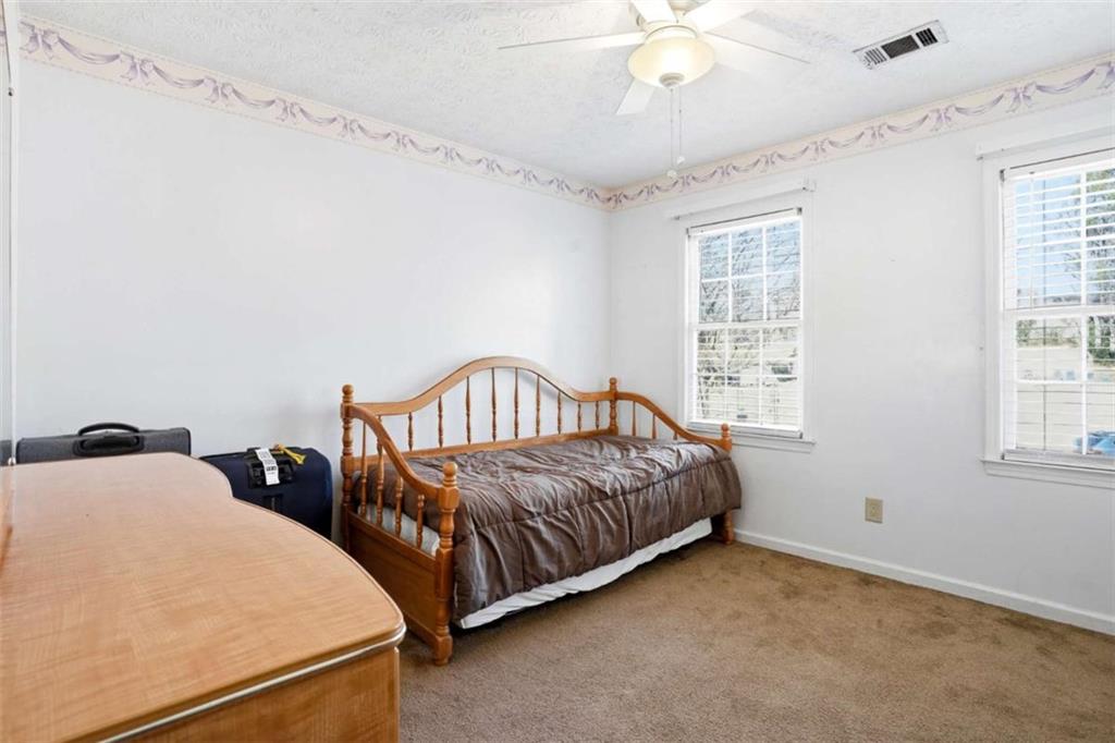 3811 Brookvale Place Decatur, GA 30034 - Photo 27 of 40 a spacious bedroom with two beds and a chandelier