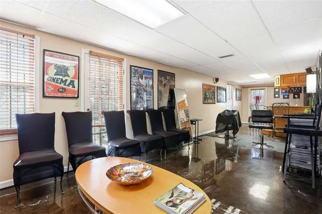 a living room with furniture a fireplace and large windows