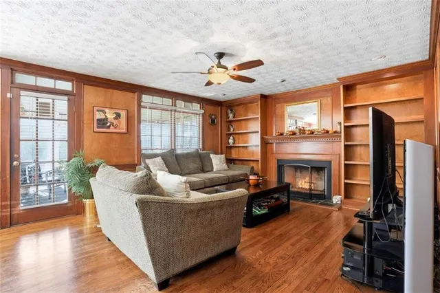 a living room with furniture a fireplace and a flat screen tv