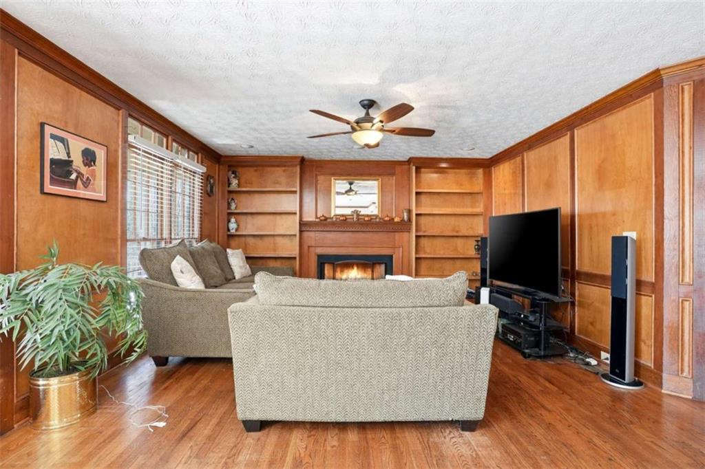 3811 Brookvale Place Decatur, GA 30034 - Photo 6 of 40 a living room with furniture a wooden floor and a flat screen tv