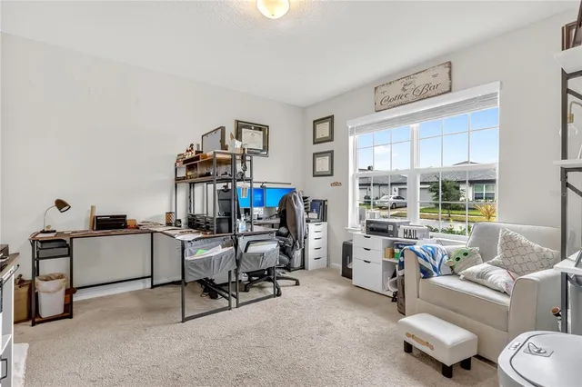 a view of a livingroom with workspace and a couch