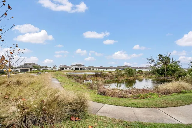 a view of a lake with houses in the back