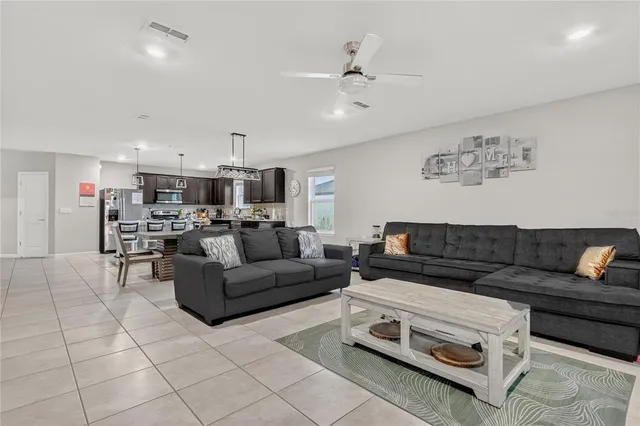 a living room with furniture and kitchen view