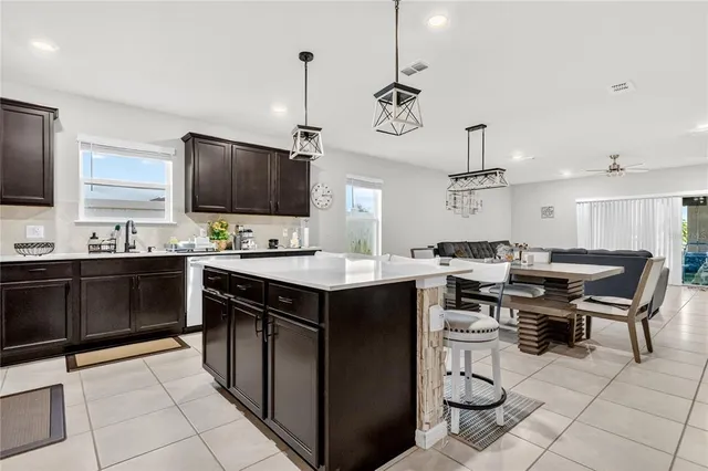 a kitchen with a sink counter and chairs