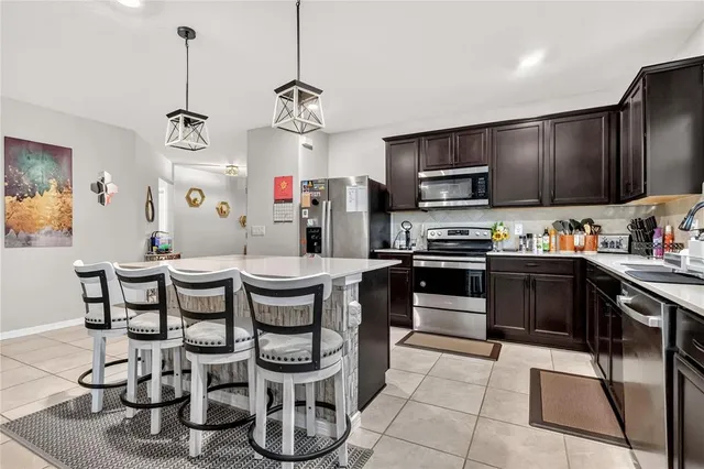 a kitchen with granite countertop a sink appliances and cabinets