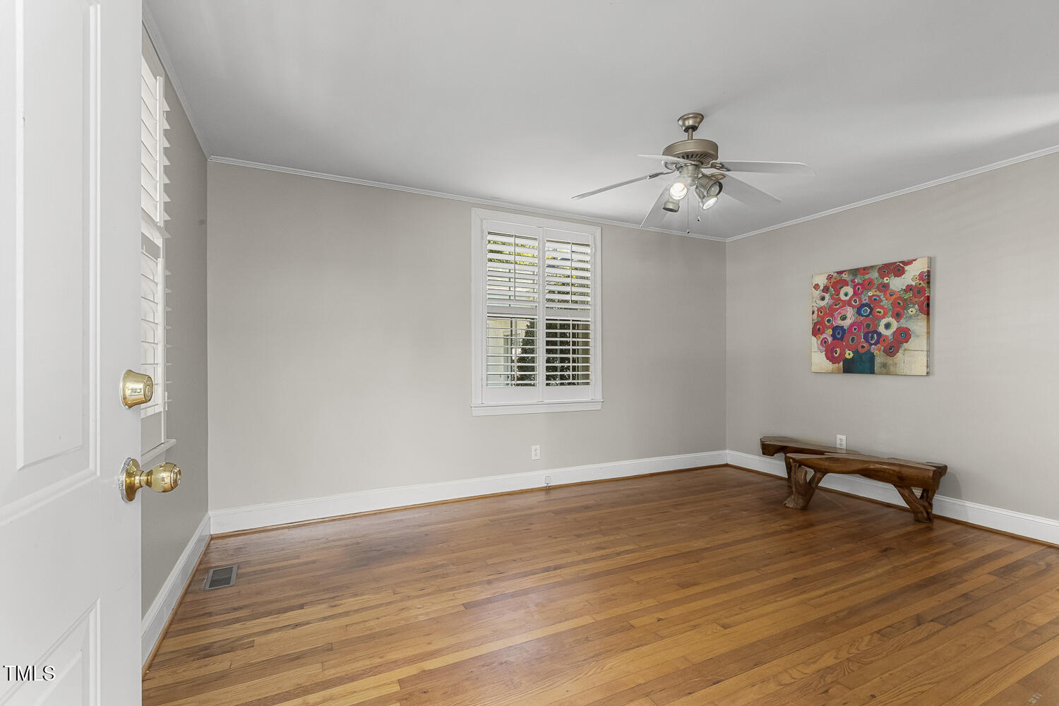 616 East Whitaker Mill Road Raleigh, NC 27608 - Photo 3 of 13 a view of an empty room with wooden floor and a window