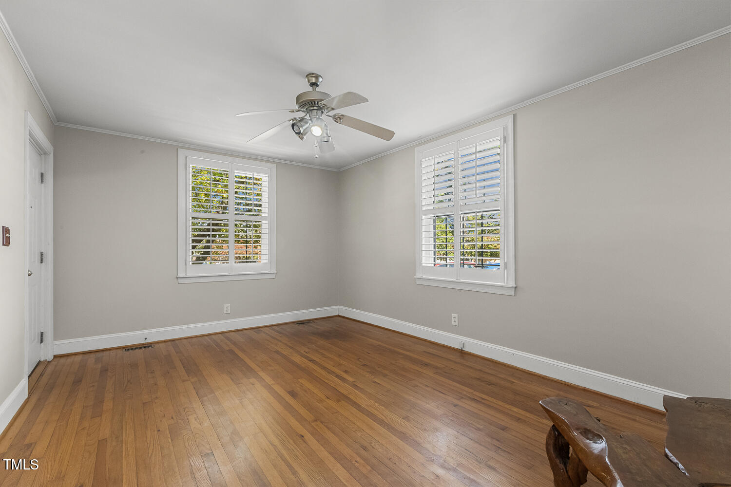 616 East Whitaker Mill Road Raleigh, NC 27608 - Photo 4 of 13 a view of an empty room with wooden floor and a window