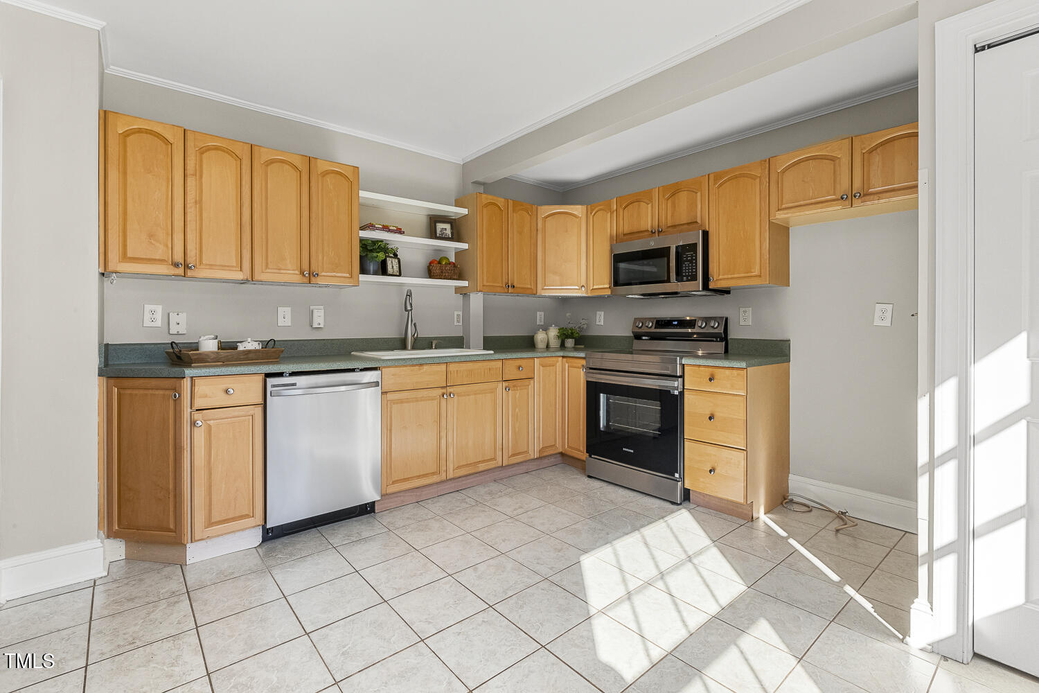 616 East Whitaker Mill Road Raleigh, NC 27608 - Photo 5 of 13 a kitchen with a sink white cabinets and white appliances