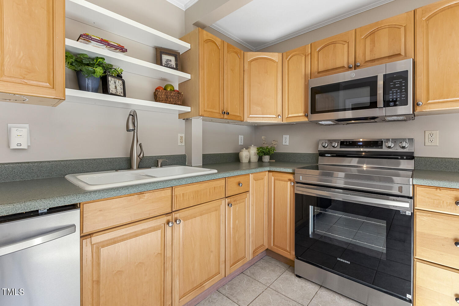 616 East Whitaker Mill Road Raleigh, NC 27608 - Photo 6 of 13 a kitchen with stainless steel appliances granite countertop a stove microwave and sink