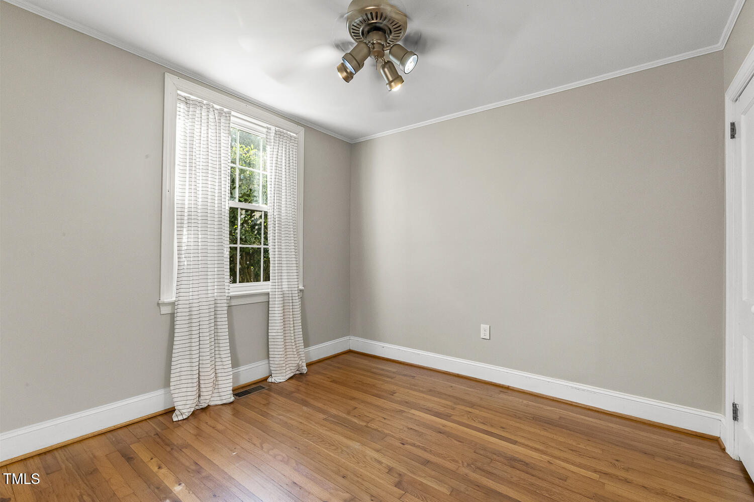 616 East Whitaker Mill Road Raleigh, NC 27608 - Photo 8 of 13 wooden floor in an empty room with a window
