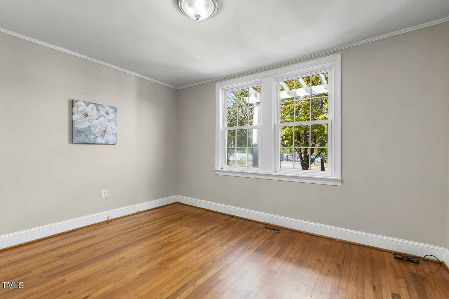616 East Whitaker Mill Road Raleigh, NC 27608 - Photo 10 of 13 wooden floor in an empty room with a window