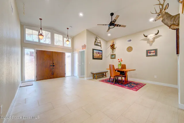 a bedroom with a bed and a ceiling fan