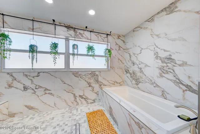 a bathroom with a bathtub and shower