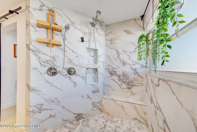 a view of a bedroom with a bed and a window