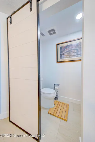 a spacious bedroom with a bed and a walk in closet