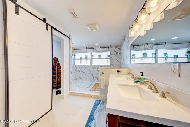 a bedroom with a large bed and a flat tv screen