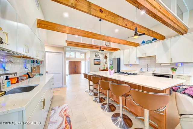 a kitchen with a sink a stove and chairs