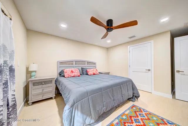 a bedroom with furniture and a flat screen tv