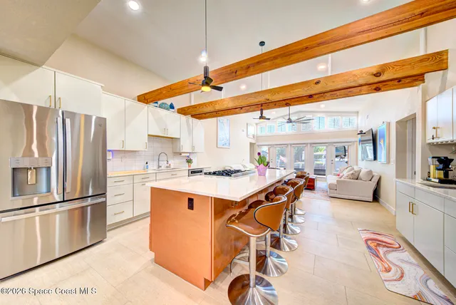 a kitchen with stainless steel appliances granite countertop a stove and a refrigerator