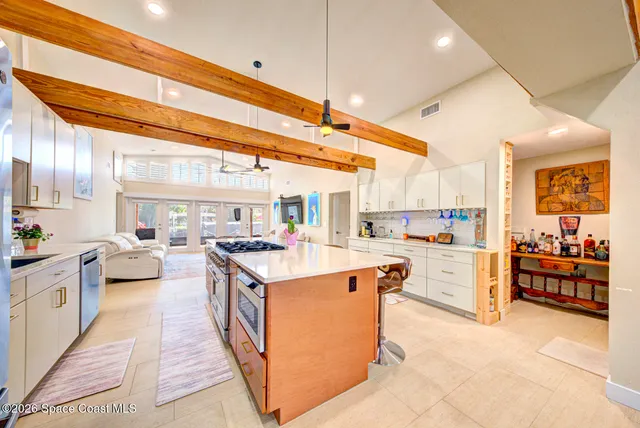 a kitchen with stove a sink and cabinets