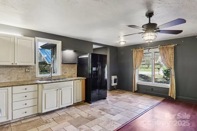 a kitchen with stainless steel appliances granite countertop a refrigerator and a sink