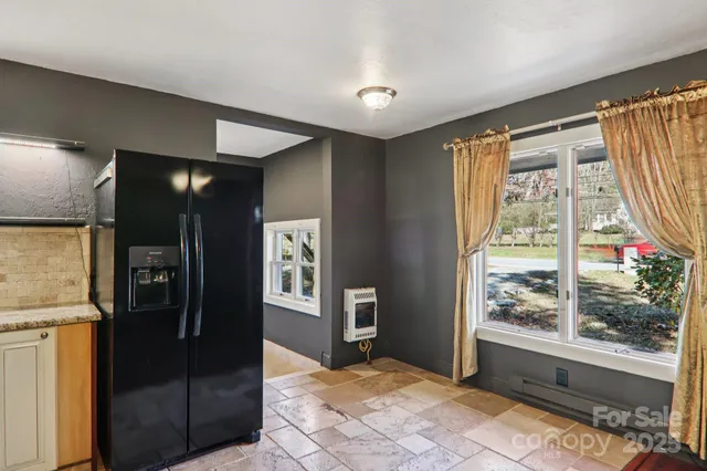 a view of a hallway with wooden floor and windows