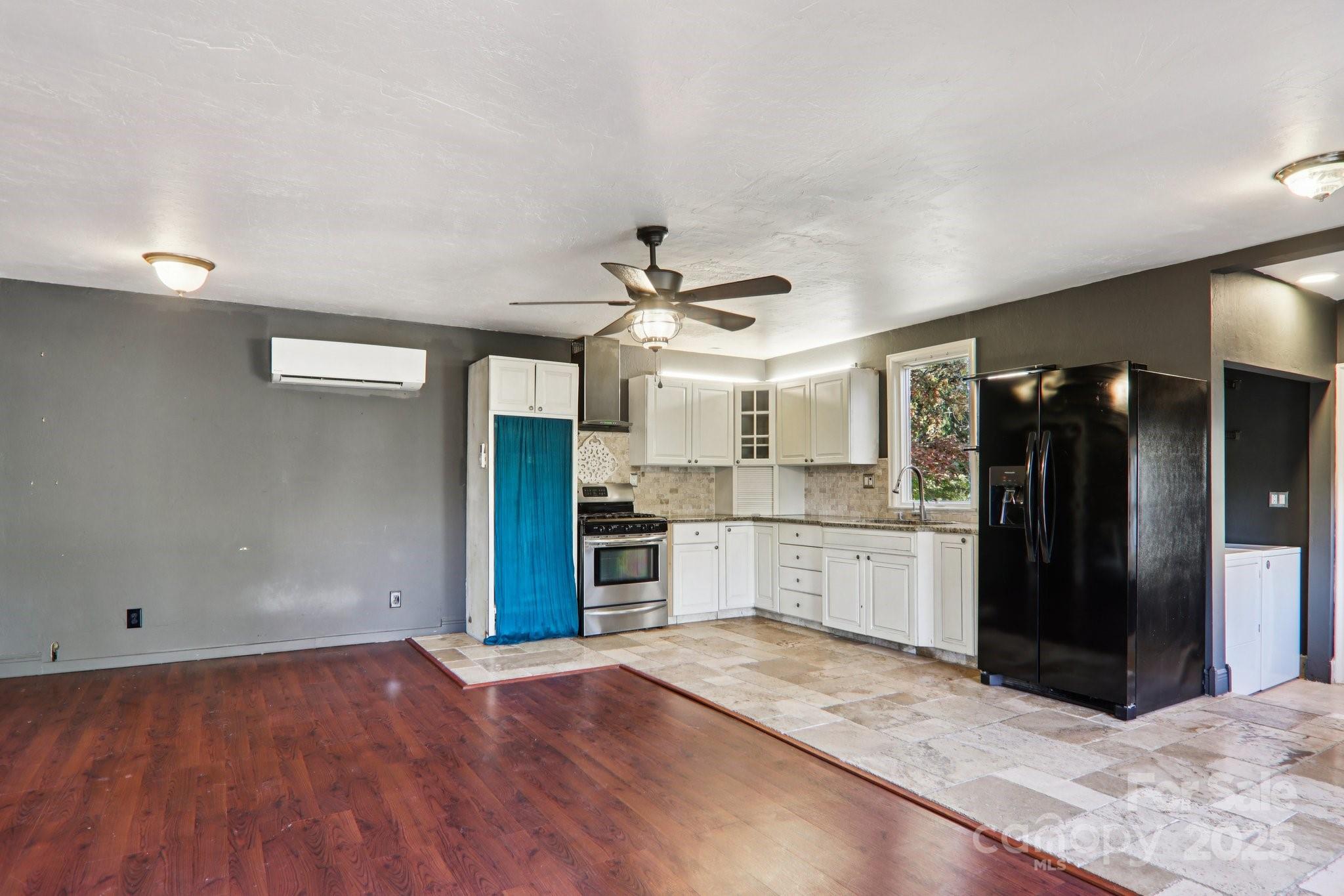 1749 Haywood Road Hendersonville, NC 28791 - Photo 14 of 48 a kitchen with granite countertop a refrigerator and a stove