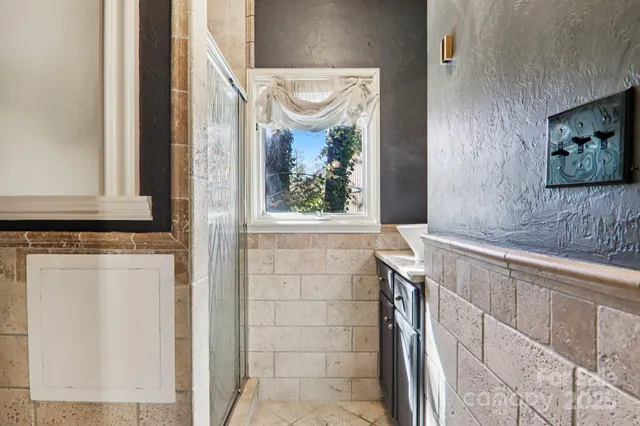 a bathroom with a bathtub and a window