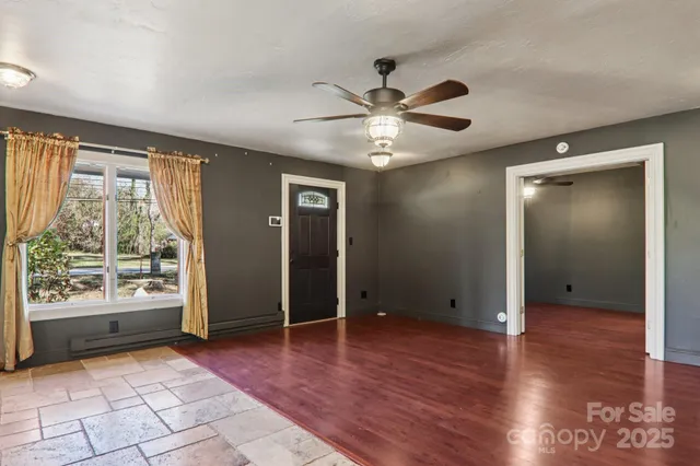 wooden floor in an empty room with a window